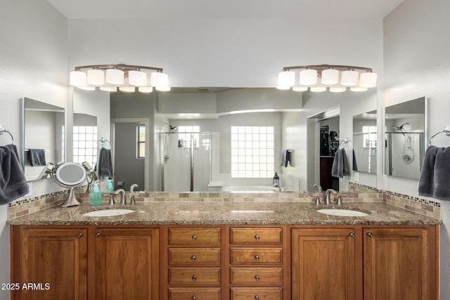 bathroom with double vanity, a sink, and a shower stall