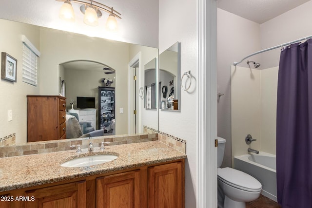 ensuite bathroom featuring toilet, shower / bath combo with shower curtain, ensuite bath, and vanity