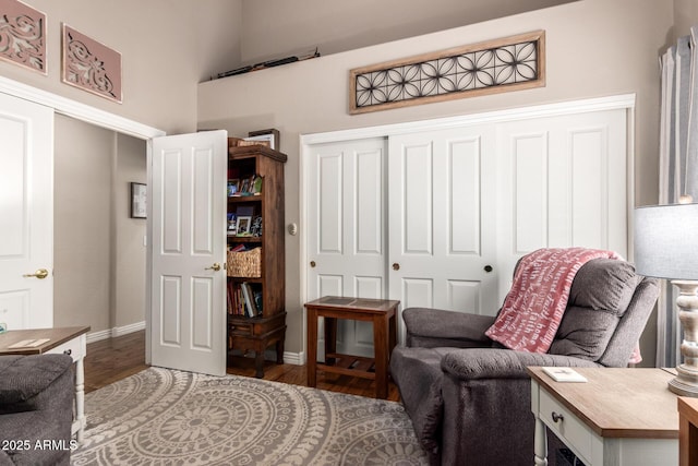 living area with wood finished floors and baseboards