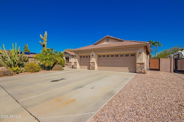 ranch-style house featuring stone siding, a gate, concrete driveway, and stucco siding