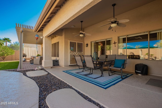 view of patio featuring outdoor dining area, ceiling fan, fence, and outdoor lounge area