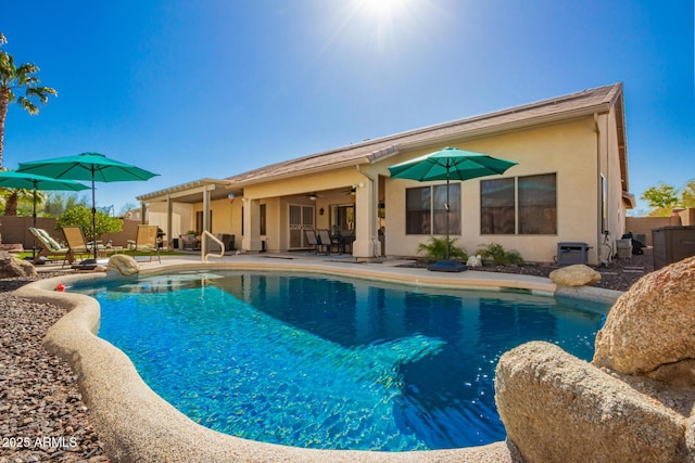 view of pool featuring ceiling fan, a fenced in pool, and a patio