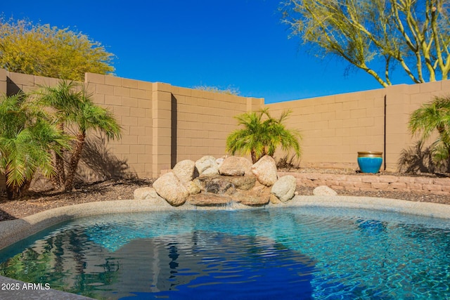 view of pool with a fenced backyard