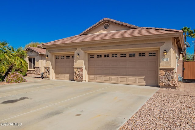 view of front of house with stone siding, concrete driveway, and stucco siding