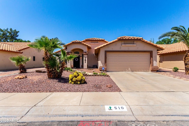 510 S Saddle St, Gilbert, AZ 85233 - mediterranean / spanish-style house with an attached garage, a tiled roof, stucco siding, and driveway