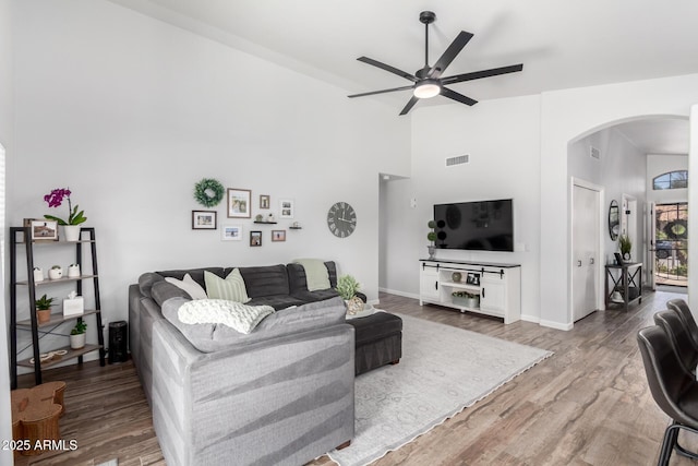 510 S Saddle St, Gilbert, AZ 85233 - living area with high vaulted ceiling, wood finished floors, ceiling fan, arched walkways, and visible vents