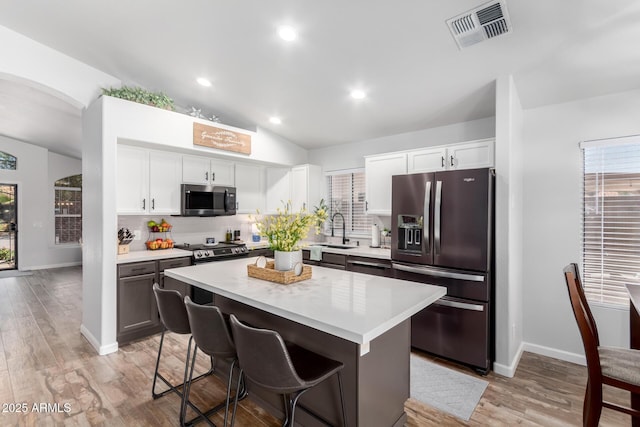 510 S Saddle St, Gilbert, AZ 85233 - kitchen with a kitchen breakfast bar, light countertops, visible vents, a sink, and appliances with stainless steel finishes