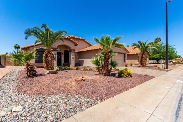 510 S Saddle St, Gilbert, AZ 85233 - mediterranean / spanish home with an attached garage, a tiled roof, driveway, and stucco siding