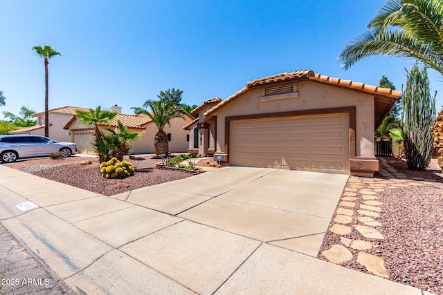 510 S Saddle St, Gilbert, AZ 85233 - view of front of home featuring a garage, driveway, a tiled roof, and stucco siding