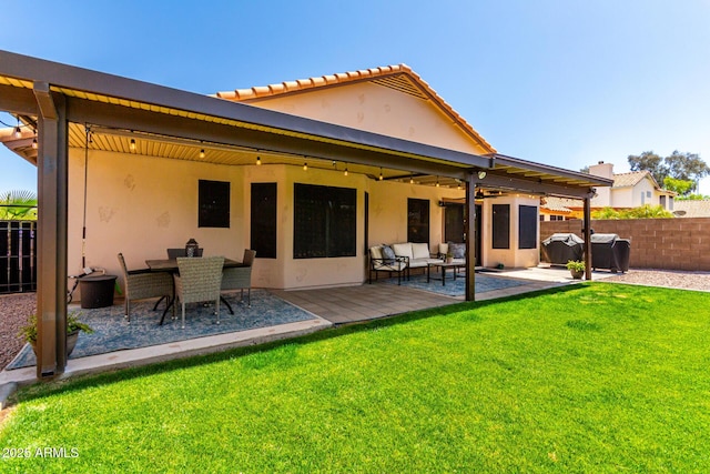 510 S Saddle St, Gilbert, AZ 85233 - back of house featuring stucco siding, an outdoor hangout area, a yard, and fence