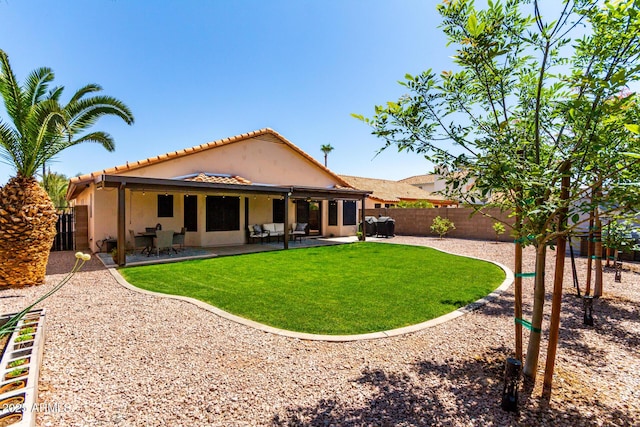 510 S Saddle St, Gilbert, AZ 85233 - rear view of property featuring a tile roof, a patio area, a lawn, a fenced backyard, and stucco siding