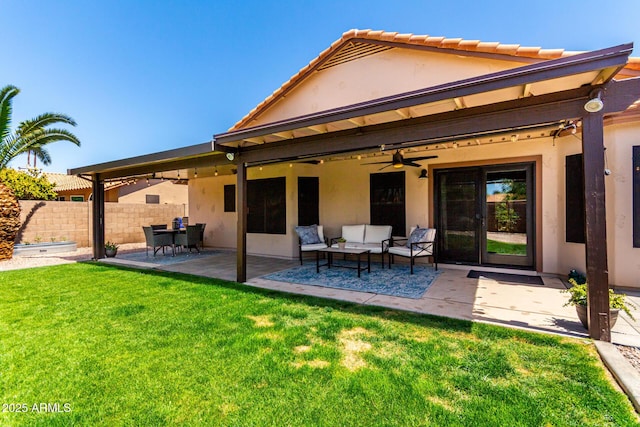 510 S Saddle St, Gilbert, AZ 85233 - rear view of house featuring fence, a ceiling fan, a lawn, a patio, and stucco siding