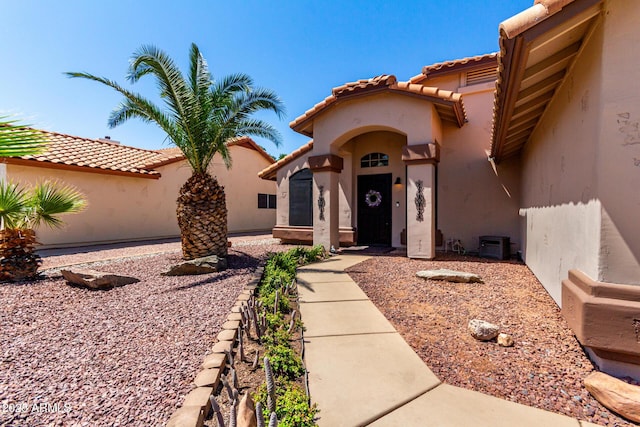 510 S Saddle St, Gilbert, AZ 85233 - view of exterior entry featuring a tile roof and stucco siding