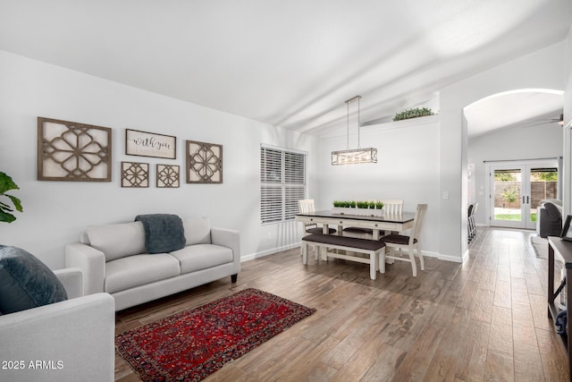 510 S Saddle St, Gilbert, AZ 85233 - living area featuring arched walkways, baseboards, a notable chandelier, lofted ceiling, and hardwood / wood-style flooring