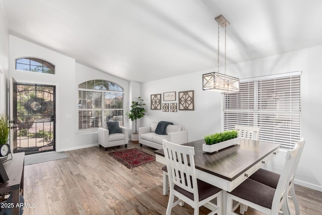 510 S Saddle St, Gilbert, AZ 85233 - dining area with vaulted ceiling, a notable chandelier, wood finished floors, and baseboards
