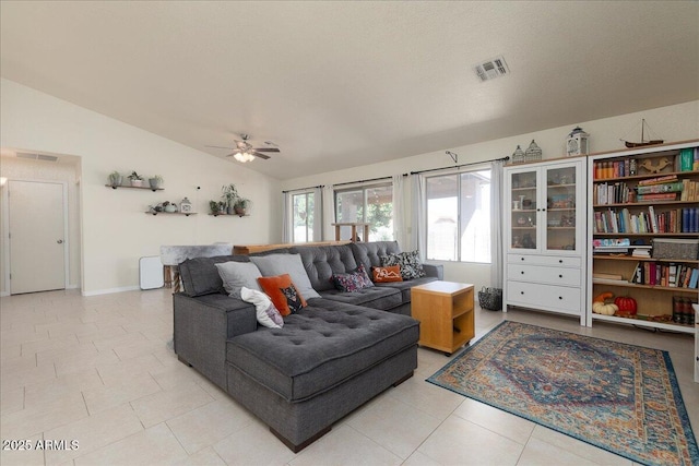 living area with lofted ceiling, light tile patterned floors, ceiling fan, and visible vents