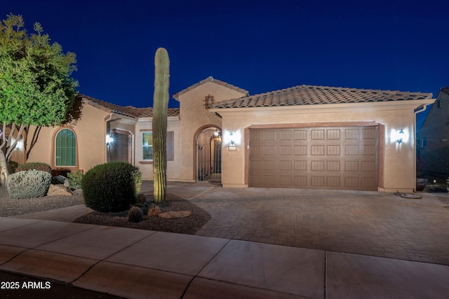 mediterranean / spanish-style home with a garage