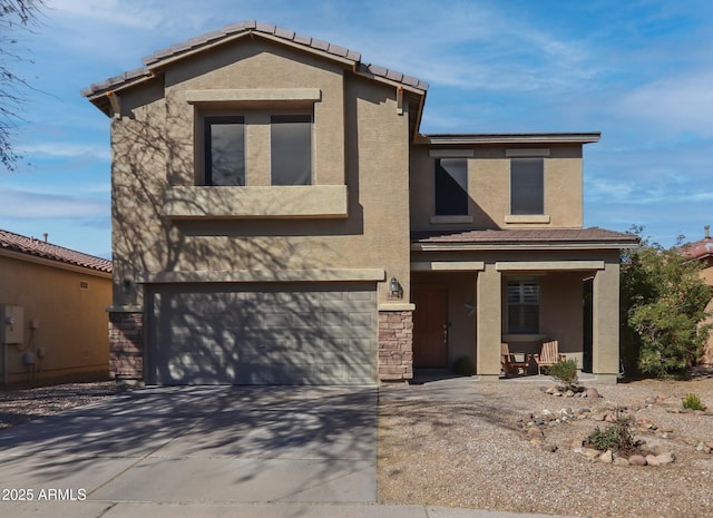 view of front of house featuring an attached garage, stone siding, driveway, and stucco siding