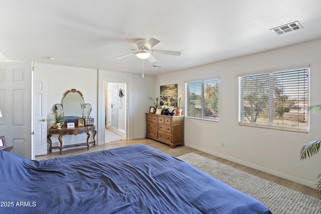 bedroom with a ceiling fan, visible vents, light wood-style flooring, and baseboards