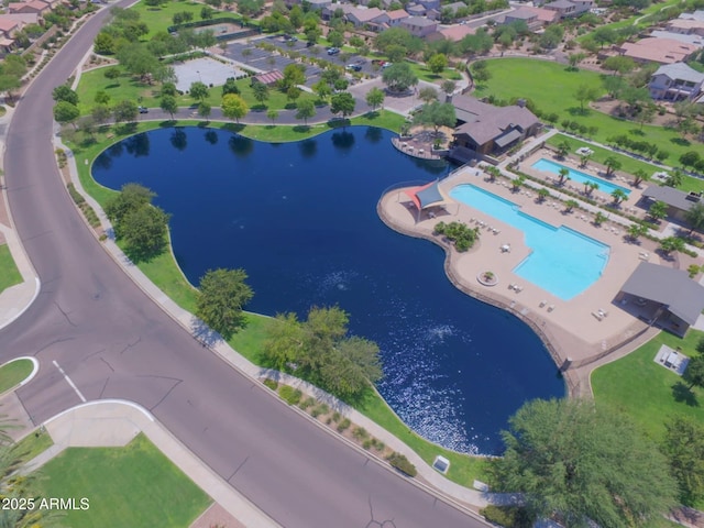 birds eye view of property with a water view