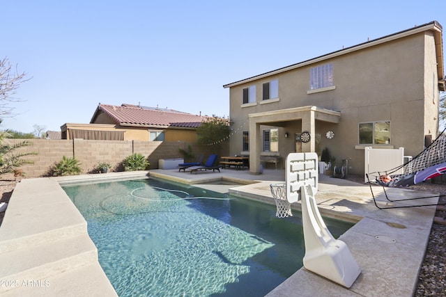 view of pool featuring a patio area, fence, and a fenced in pool