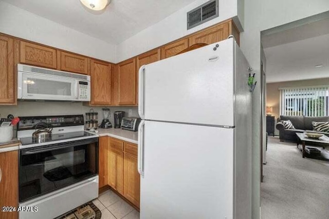 kitchen with light tile patterned floors and white appliances