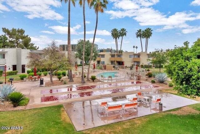 view of home's community featuring a swimming pool and a patio