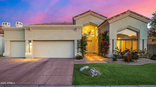 7439 E Beryl Ave, Scottsdale, AZ 85258 - view of front facade featuring a garage, driveway, stucco siding, and a lawn