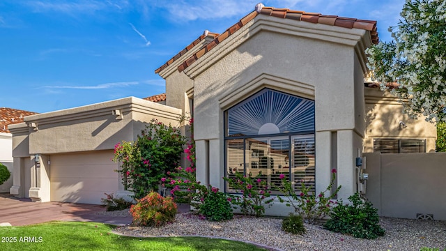 7439 E Beryl Ave, Scottsdale, AZ 85258 - view of front of property featuring stucco siding, an attached garage, and a tiled roof