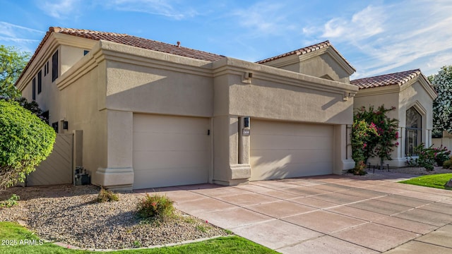 7439 E Beryl Ave, Scottsdale, AZ 85258 - view of front facade with a garage, stucco siding, a tiled roof, and driveway