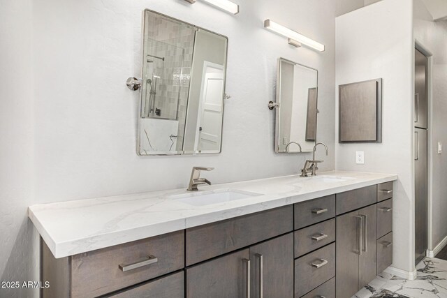 7439 E Beryl Ave, Scottsdale, AZ 85258 - full bathroom featuring marble finish flooring, double vanity, baseboards, and a shower