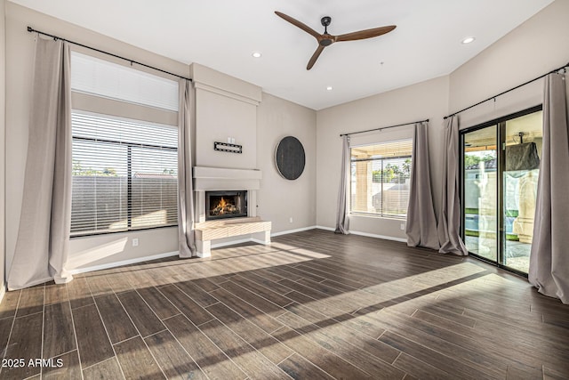 7439 E Beryl Ave, Scottsdale, AZ 85258 - unfurnished living room featuring a lit fireplace, a ceiling fan, baseboards, wood finished floors, and recessed lighting