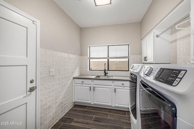 7439 E Beryl Ave, Scottsdale, AZ 85258 - laundry area with cabinet space, tile walls, washer and clothes dryer, dark wood-style flooring, and a wainscoted wall