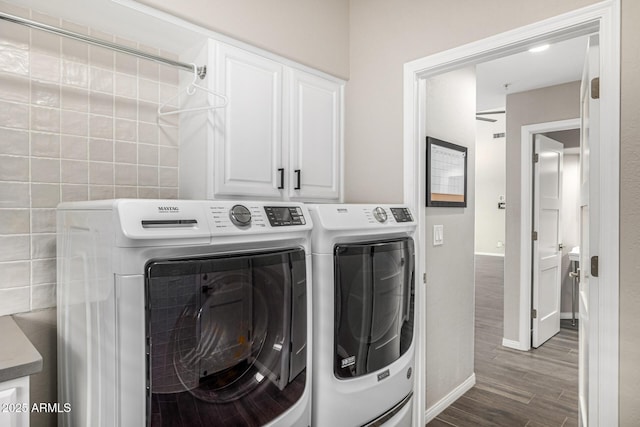 7439 E Beryl Ave, Scottsdale, AZ 85258 - laundry room featuring independent washer and dryer, cabinet space, dark wood-type flooring, and baseboards
