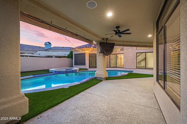7439 E Beryl Ave, Scottsdale, AZ 85258 - pool at dusk with ceiling fan, a patio, and a pool with connected hot tub