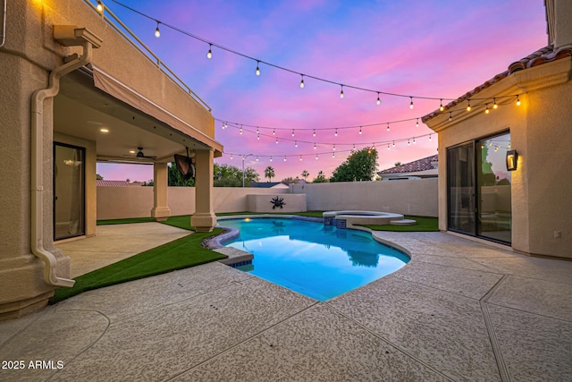 7439 E Beryl Ave, Scottsdale, AZ 85258 - pool at dusk with a patio, a fenced backyard, and a pool with connected hot tub