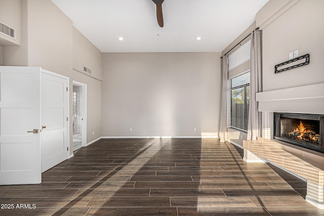 7439 E Beryl Ave, Scottsdale, AZ 85258 - unfurnished living room featuring a ceiling fan, a lit fireplace, wood finished floors, recessed lighting, and baseboards