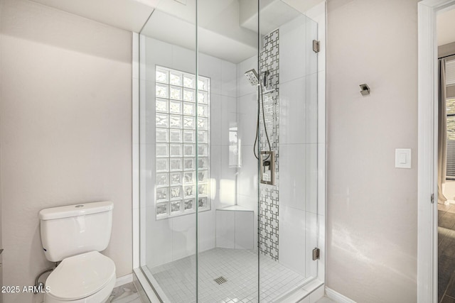 7439 E Beryl Ave, Scottsdale, AZ 85258 - bathroom featuring toilet, a stall shower, and baseboards