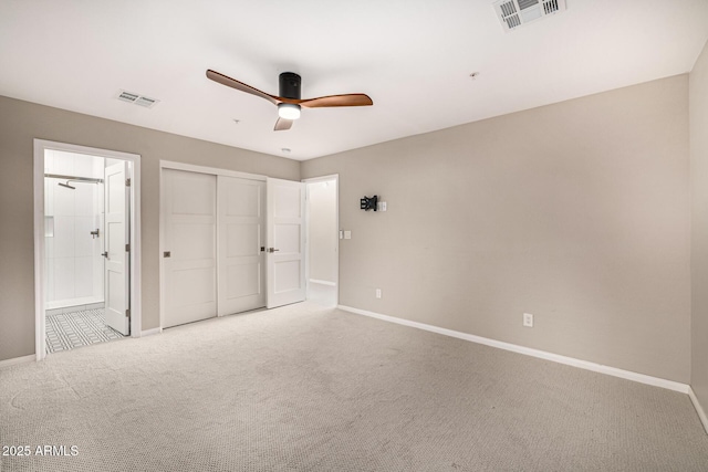 7439 E Beryl Ave, Scottsdale, AZ 85258 - unfurnished bedroom featuring baseboards, light colored carpet, ensuite bathroom, a closet, and a ceiling fan