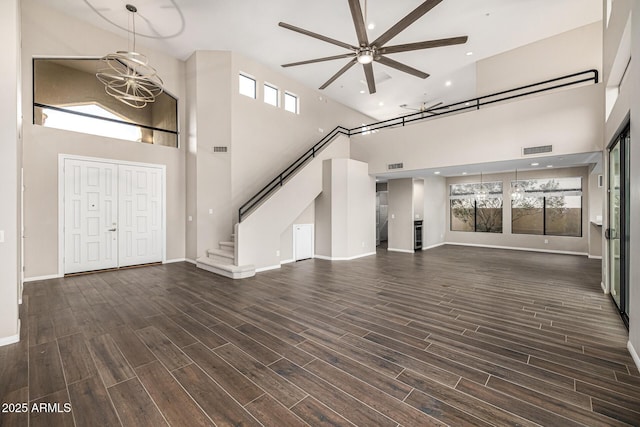 7439 E Beryl Ave, Scottsdale, AZ 85258 - unfurnished living room featuring a high ceiling, a ceiling fan, recessed lighting, baseboards, and stairs