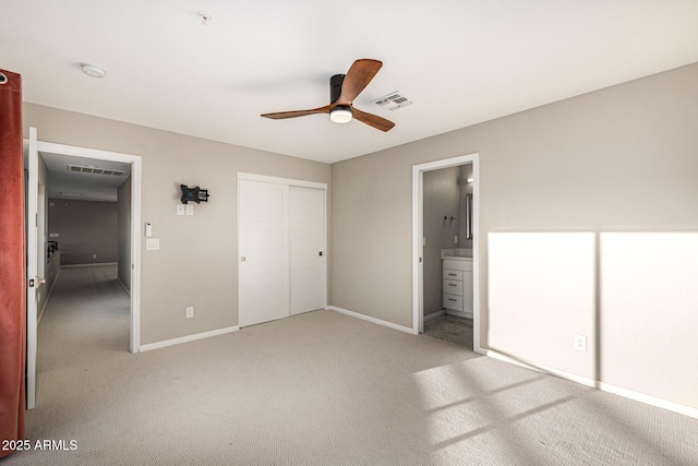 7439 E Beryl Ave, Scottsdale, AZ 85258 - unfurnished bedroom with light carpet, baseboards, a closet, ensuite bath, and ceiling fan