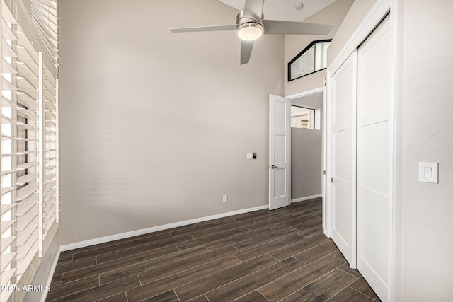 7439 E Beryl Ave, Scottsdale, AZ 85258 - unfurnished bedroom featuring dark wood finished floors, a closet, baseboards, a towering ceiling, and a ceiling fan