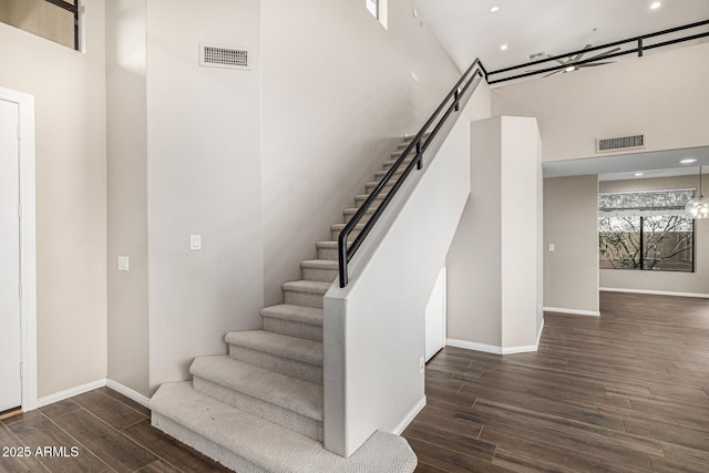 7439 E Beryl Ave, Scottsdale, AZ 85258 - stairs featuring a towering ceiling, wood finished floors, baseboards, and recessed lighting