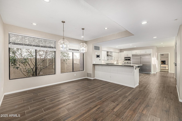 7439 E Beryl Ave, Scottsdale, AZ 85258 - kitchen with stainless steel appliances, dark wood finished floors, a peninsula, white cabinets, and recessed lighting
