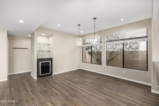 7439 E Beryl Ave, Scottsdale, AZ 85258 - unfurnished living room with beverage cooler, baseboards, dark wood-style floors, and recessed lighting