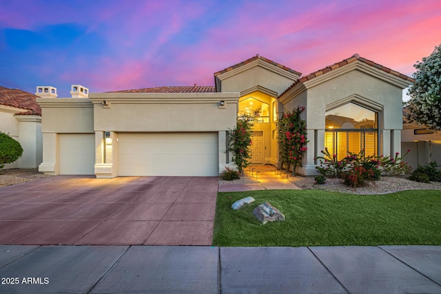 7439 E Beryl Ave, Scottsdale, AZ 85258 - view of front of property with an attached garage, driveway, stucco siding, and a yard