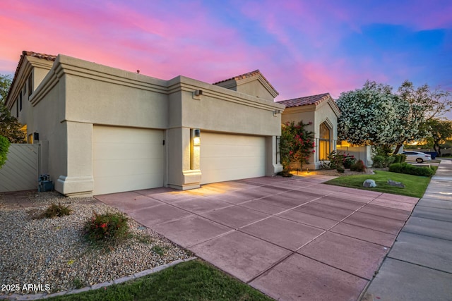 7439 E Beryl Ave, Scottsdale, AZ 85258 - view of front of home with a garage, stucco siding, driveway, and a tile roof