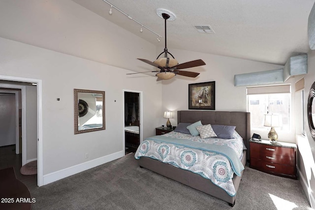 bedroom with ceiling fan, ensuite bathroom, carpet flooring, and lofted ceiling