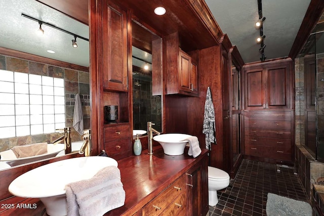 bathroom featuring toilet, tile patterned flooring, and ornamental molding