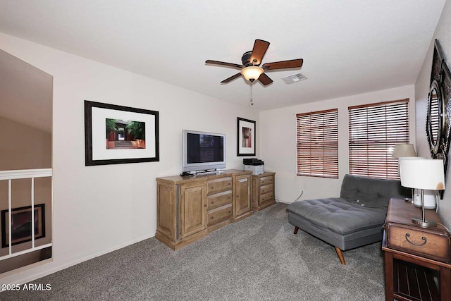 living area with carpet floors and ceiling fan